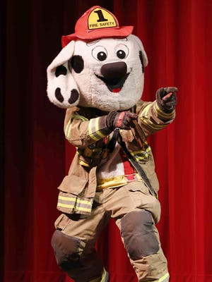 For several local children, Sparky the fire dog was their favorite part of the show.
Sparky is introduced during the annual Fire Prevention Show presented by Lafayette and West Lafayette fire departments Wednesday, October 9, 2013, at Rohrman Performing Arts Auditorium at Jefferson High School.