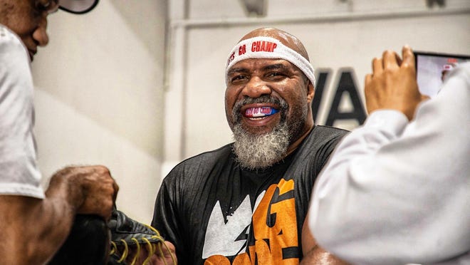 Shannon Briggs, sporting his 'Let's Go Champ' headband, works out before the coronavirus' social isolation edict.