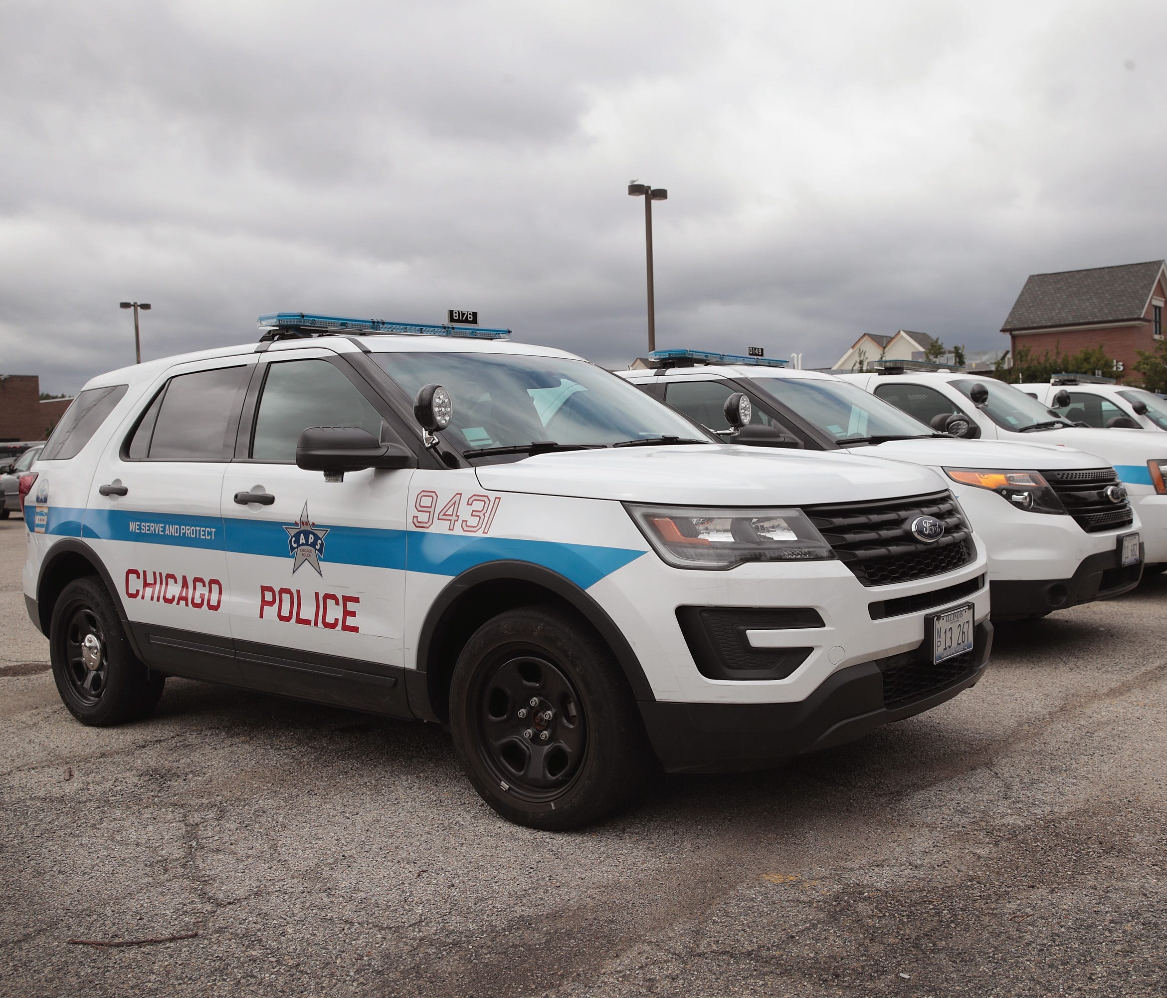 Ford Explorer-based Police Interceptors sit in a police station parking  in Chicago. Police departments are beginning to take the SUVs out of service because the say fumes from the exhaust system are seeping into the SUVs passenger compartment and ma