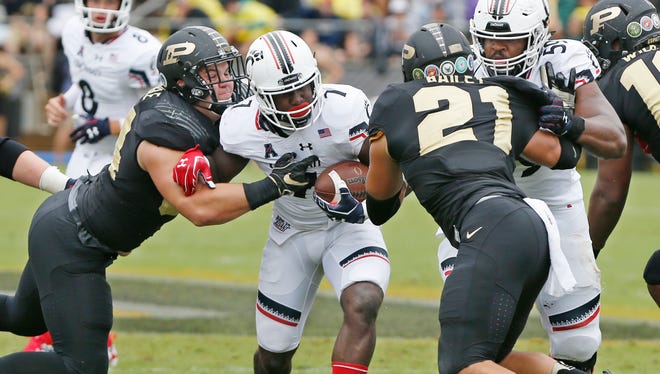 Cincinnati's Tion Green is wrapped up by the Purdue defense Saturday, September 10, 2016, at Ross-Ade Stadium. Cincinnati defeated Purdue 38-20.
