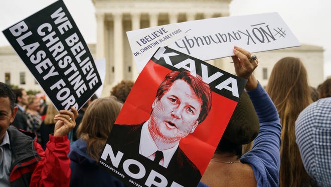 Demonstrators gather at the Supreme Court Monday to protest the confirmation of  Brett Kavanaugh, who has been accused of sexual assault by two women.