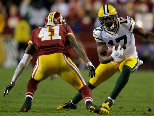 Green Bay Packers receiver Davante Adams tries to get