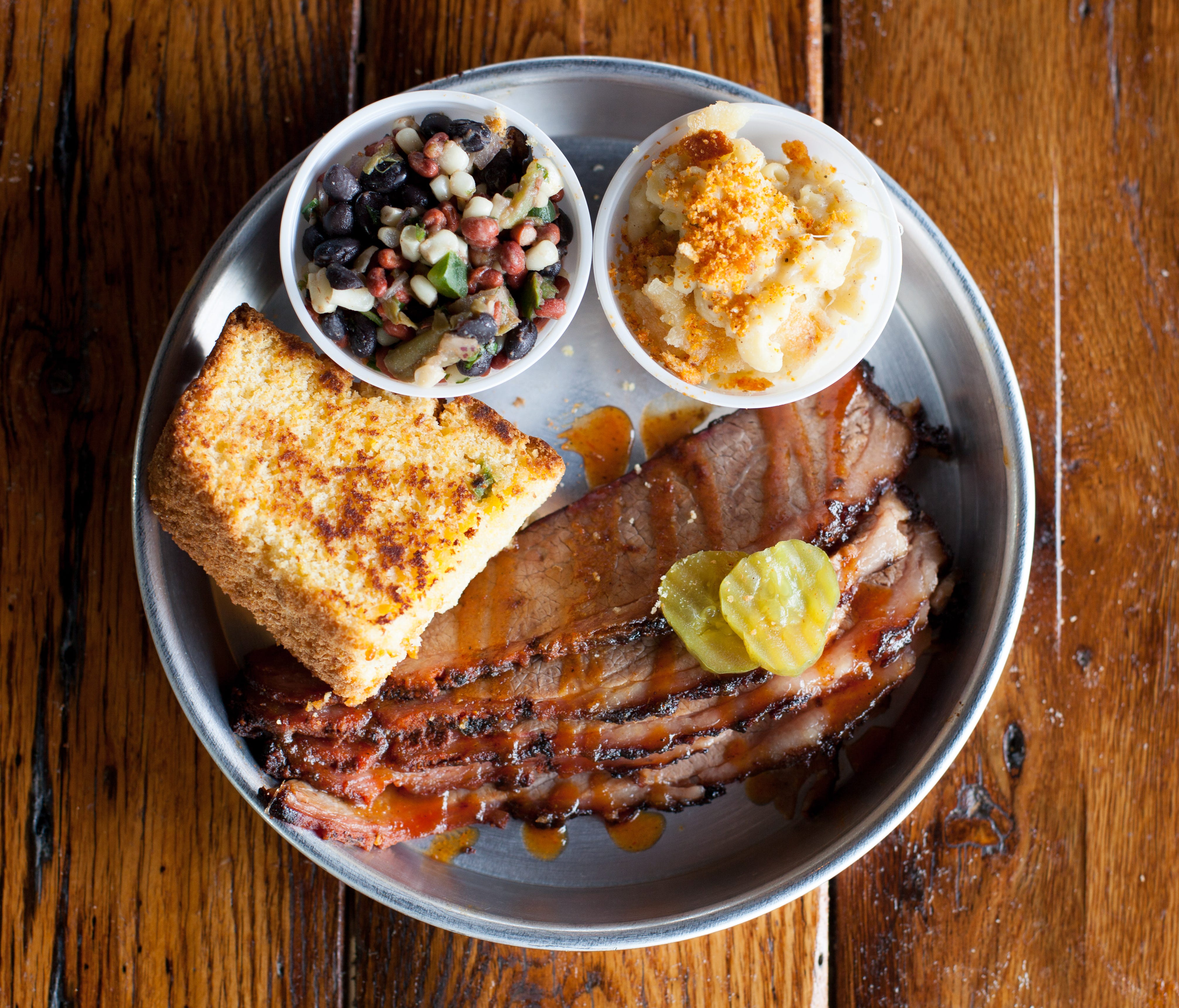 Edley's serves barbecue sandwiches, platters and tacos, such as the brisket platter with cornbread, bean salad and mac-n-cheese.