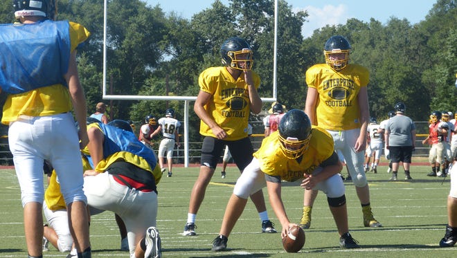 Leslie Cummings (center) gets ready for a snap during a recent Enterprise High football practice.