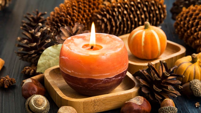 Autumn candle decoration with cones,moss,cinnamon sticks, acorns,anise and pumpkins