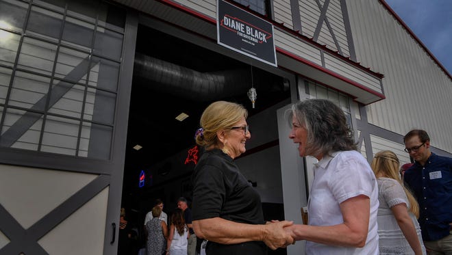 U.S. Representative Diane Black greets with Marita Dell-Aquila outside the Johnson's Antique Car Barn in Franklin, Tenn., Sunday, June 24, 2018.