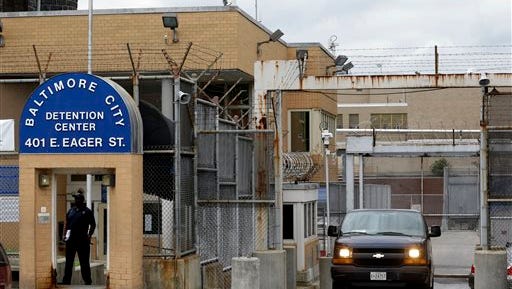 In this  file photo, an inmate transport van departs from the Baltimore City Detention Center in Baltimore. Federal prosecutors said today that a federal jury in Baltimore has convicted two of the jail's guards, two inmates and a kitchen worker for their roles in a massive jailhouse drug and cellphone smuggling scheme. The defendants were part of a sweeping 44-person indictment handed down in 2013.