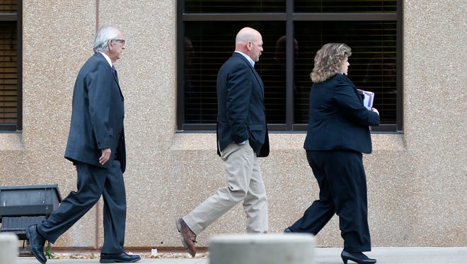 Joey Kyle (center) walks in the the Federal Courthouse on Wednesday, May 20, 2015.