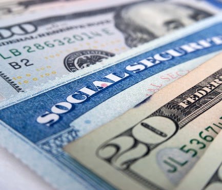Social Security card inserted in money.