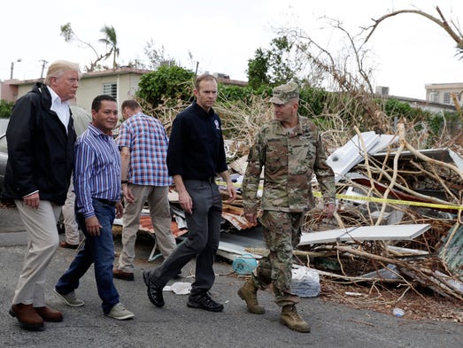 President Donald Trump takes a walking tour to survey