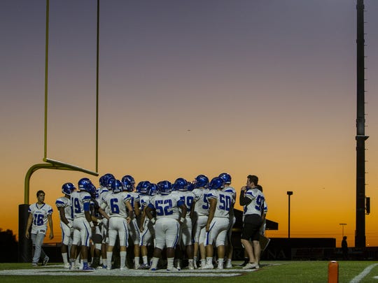 Dobson players huddle before a game against Red Mountain
