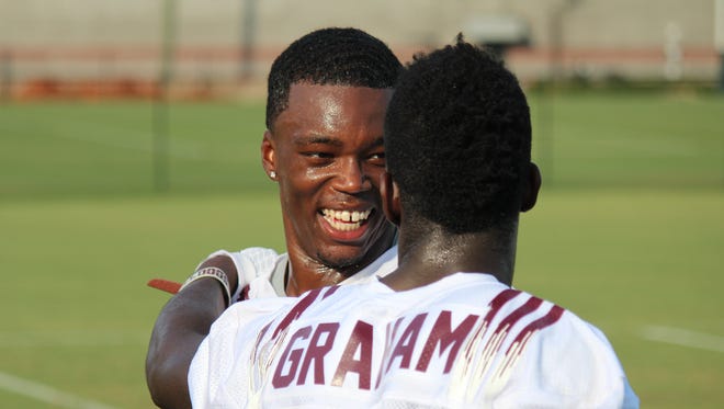 Mississippi State corners Jamoral Graham and Will Redmond joke during practice.