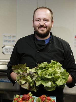 Jordan Stephenson, owner/chef, is photographed with fresh Kentucky grown produce at Stephenson Mill Tavern & Grill in May.