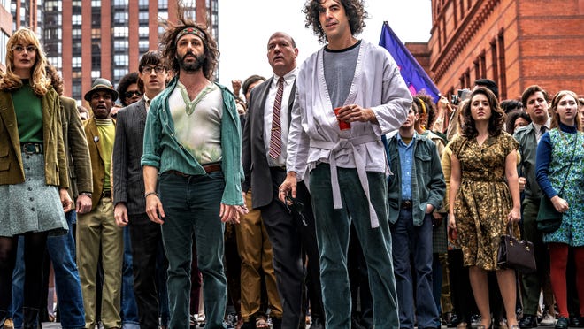 Jerry Rubin (Jeremy Strong), Dave Dellinger (John Carroll Lynch), and Abbie Hoffman (Sacha Baron Cohen) get ready to lead protestors through Chicago.