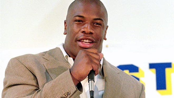 Former NFL player Lawrence Phillips was found unresponsive in his prison cell and later pronounced dead. He is shown here answering questions at a news conference in St. Louis in 1996.