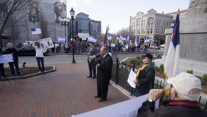 Supporters of HB2 demonstrate Saturday at Pack Square in the foreground while opponents hold a counter-demonstration in the background