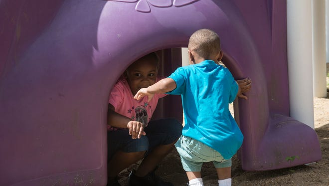 Ken'Cory Gardner, 4, and Ne'Cori Gardner, 5, play at Vaughn Road Park in Montgomery on Wednesday, July 8, 2015.  The siblings are two of the 86 children who became ill from food poisoning at Sunny Side Day Care Center two weeks ago. The mom has filed a lawsuit against the owners of the center. 