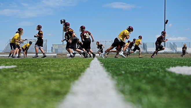 Harrisburg High School football players run through a drill during a practice Tuesday, Aug. 16, 2016, at the Harrisburg High School in Harrisburg, S.D.