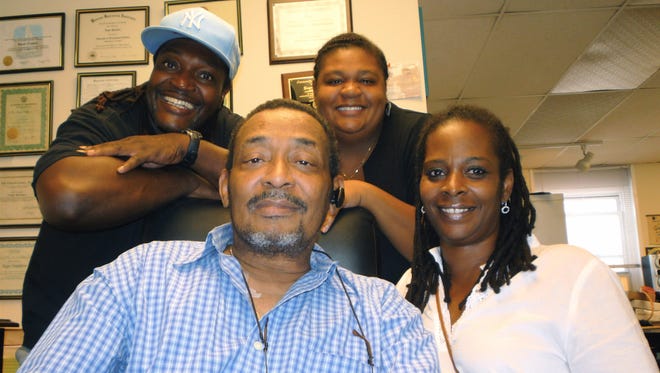 Roger Hamilton, center, is joined by comedian James "Uncle Jimmy Mack" McNair, daughter Shai Hamilton and Deborah Walker, fellow organizers of the upcoming benefit Gospel Show and Praise Dance Competition. Hamilton's charitable efforts, like playing Santa to city kids, continue despite his medical woes, including a kidney transplant and recent double foot amputations. The  latest effort is set for Aug. 28 at the Paramount Center for the Arts.  (Brian Howard/The Journal News)