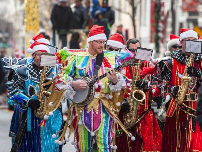 
Members of the Woodland String Band play in the Wilmington Jaycees Christmas Parade along Market Street on Saturday morning.
