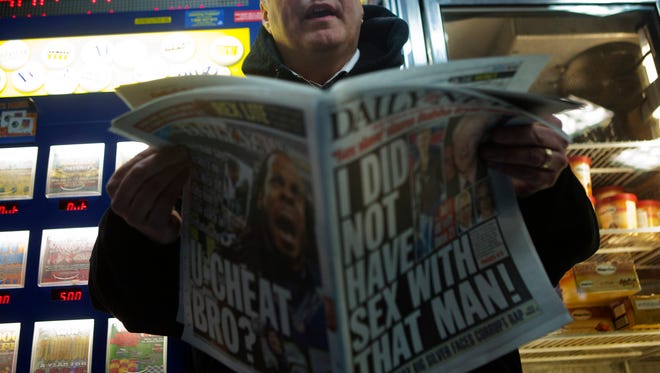 Kerry Burke, reporter for the New York Daily News, buys a copy of his newspaper on  Jan. 22, 2015.