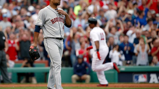 Boston Red Sox's Rafael Devers, right, rounds the bases after his two-run home run off Houston Astros relief pitcher Francisco Liriano, left, during the third inning in Game 3 of baseball's American League Division Series, Sunday, Oct. 8, 2017, in Boston. (AP Photo/Michael Dwyer)