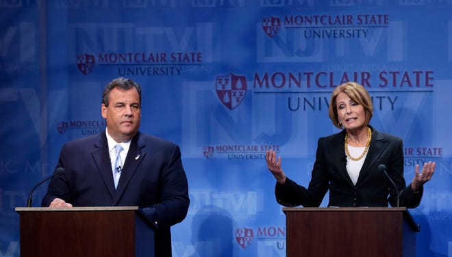 Republican New Jersey Gov. Chris Christie, left, listens as Democratic challenger Barbara Buono gives a final statement during their debate at Montclair University on Oct. 15.