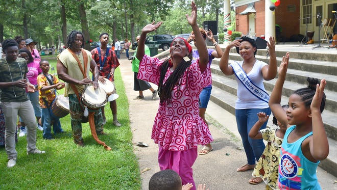 Chiquila Pearson and Jerry Jenkins, left, of Hasan Drums, leads Kuku or celebration dance during Jackson's Juneteenth Celebration Saturday in Battlefield Park.