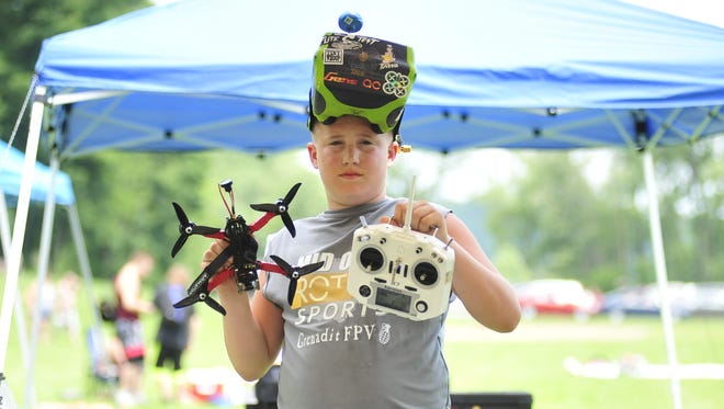 Luke Gearhart, 11, of Bellville, shows off his new drone Saturday between races as Pleasant Hill Lake Park.