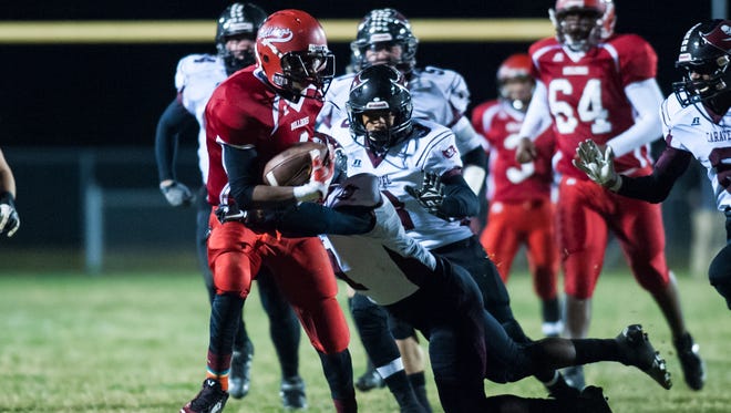 
Laurel running back Chuckie Auguste rushes for a first down against Caravel in Laurel on Friday evening.
