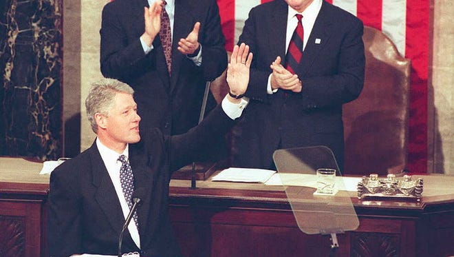 WASHINGTON, DC - JANUARY 24:  US President Bill Clinton waves to members of Congress 24 January 1995 as Speaker of the House of Representatives Newt Gingrich (above,R) and Vice President Al Gore(above, L) applaud before the beginning his second State of the Union address. In his speech, President Clinton called for a new social compact,  "to meet the challenges of our times."   (COLOR KEY: Flag has red stripes.)  AFP PHOTO  (Photo credit should read LUKE FRAZZA/AFP/Getty Images)