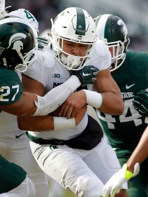 Michigan State running back Connor Heyward drags defenders into the end zone for a touchdown during MSU's spring game Saturday at Spartan Stadium.