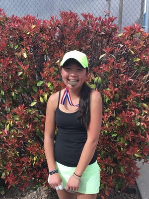 Farmington's Emily Nguyen poses with her first-place singles flight medal after her match in the Chapin Invitational in El, Paso, Texas.