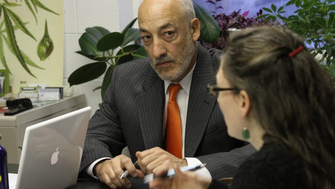 Matthew R. Abel, an attorney specializing in medical marijuana cases, meets in January 2012 with Brandy Zink and others leading the effort to legalize small amounts of marijuana.
