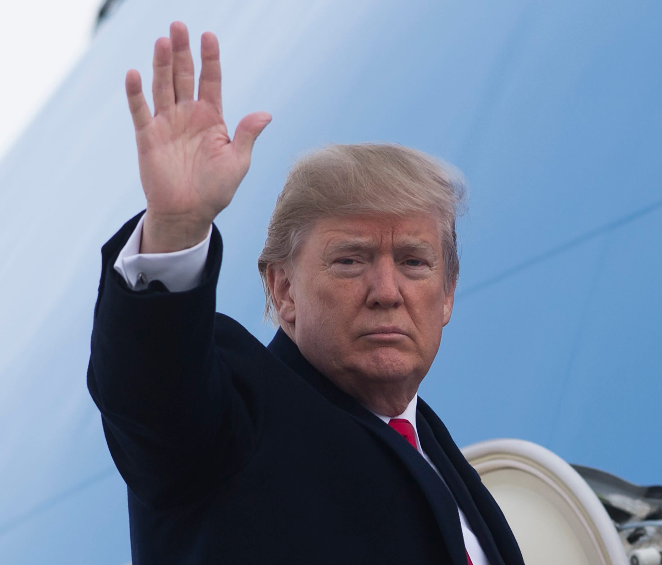 President Trump waves from Air Force One before leaving for Utah Monday.