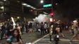 Police throw gas canisters at protesters outside the