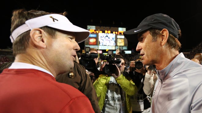 Oklahoma's Bob Stoops (left) and Baylor's Art Briles share a moment after the Bears beat the Sooners 42-12 last season. They're the Big 12 football favorites.