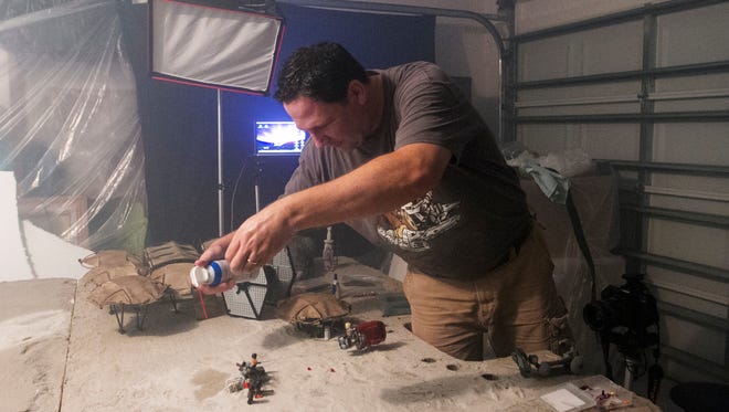 Diorama artist and photographer Stephen Hayford works on his latest project, a Star Wars scene for Lego, at his studio.