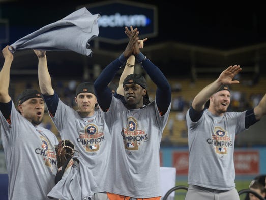 Astros players celebrate on the field at Dodger Stadium.
