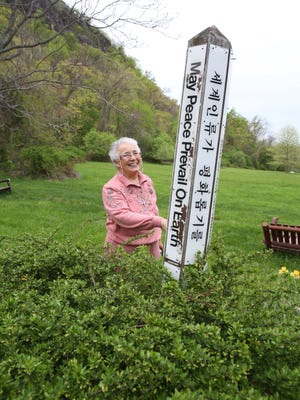 Sister Veronica Mendez, president of Sisters of Our Lady of Christian Doctrine, stands near the Peace Pole at the Marydell Faith and Life Center in Upper Nyack on May 6.