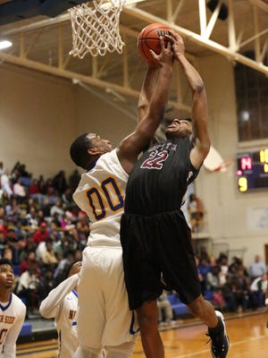 Liberty's Demarious Bond (22) fights for the rebound against North Side's Jerry Robertson on Friday.