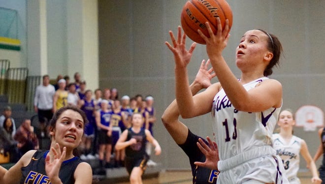 North Kitsap's Olivia Selembo (right) scores off a first-half steal against Fife.