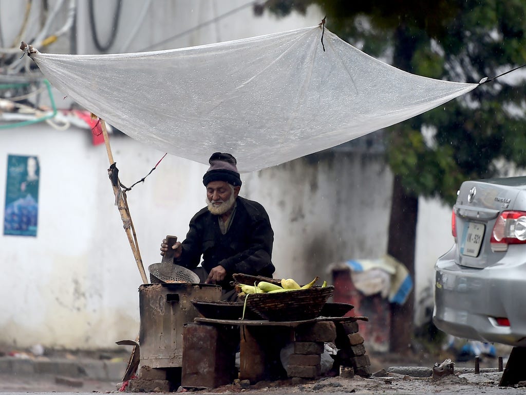 A Pakistani vendor prepares corn at a roadside in Islamabad, Pakistan.