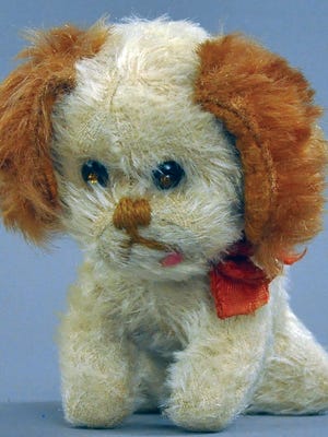 This 1930s Schuco toy spaniel with brown ears, a white body and a stitched nose and mouth sold for $900, which was three times the estimate.