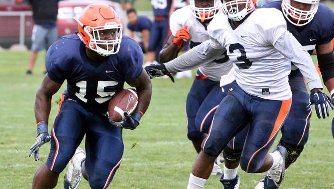 UTEP running back Kevin Dove, 15, finds running room against the UTEP defense during their final scrimmage game Sunday at Camp Ruidoso. 