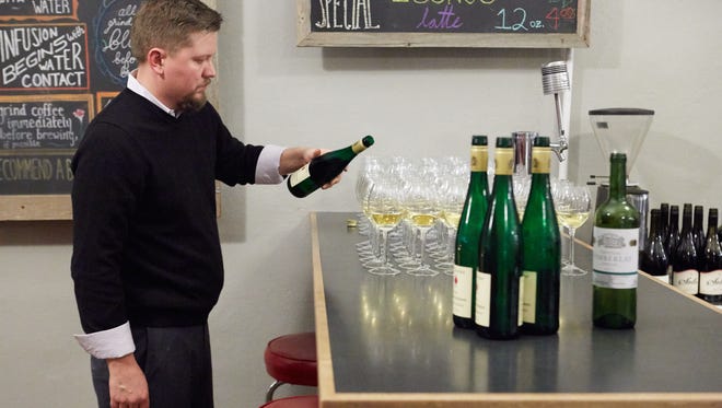 Sommeilier James Gurley pours a Dr. Fischer Riesling Cabinet "Ockfener Beckstein" for the second course during the Fort Collins Secret Supper in Janurary.