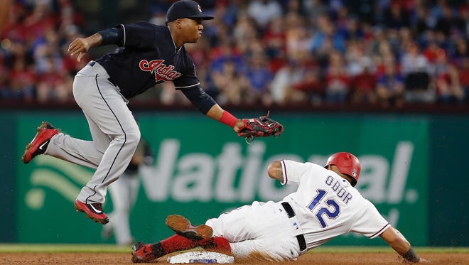 Cleveland Indians second baseman Jose Ramirez, left, forces out Texas Rangers Rougned Odor (12) during the second inning of a baseball game Tuesday, April 4, 2017, in Arlington, Texas.