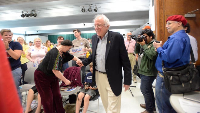 Bernie Sanders enters a packed town hall meeting in Iowa City, Iowa, on Saturday morning, May 30, 2015.