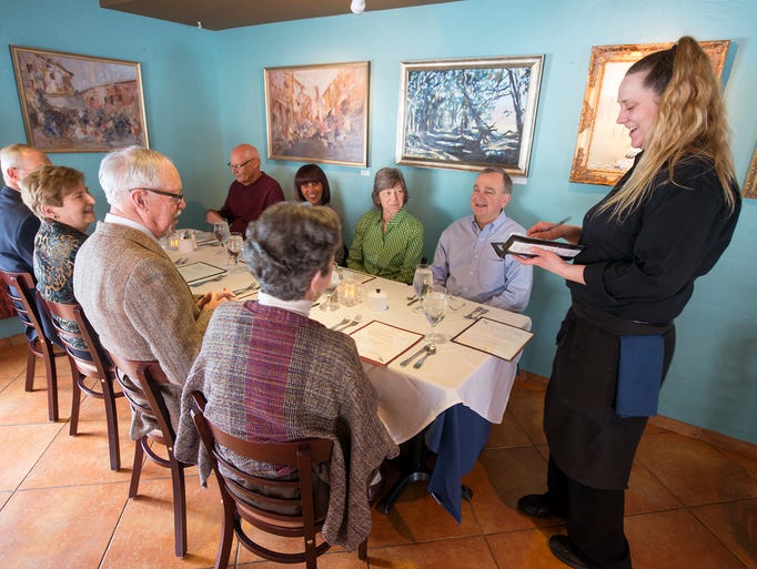 Shannon Smith, right, takes an order for a party of