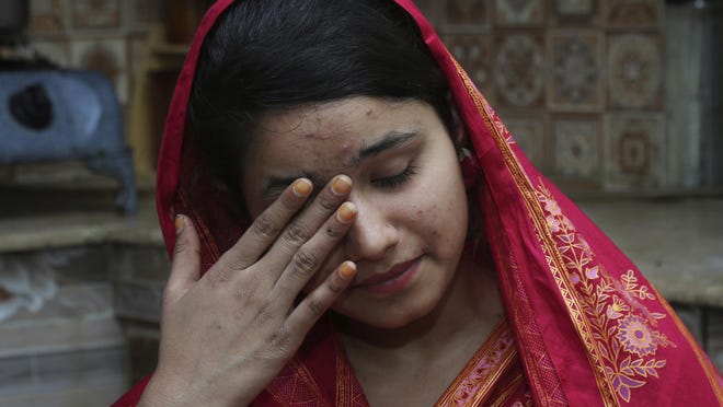 In this April 14, 2019 photo, Mahek Liaqat weeps while she recounts her ordeal in an arranged marriage to a Chinese national, in Gujranwala, Pakistan.